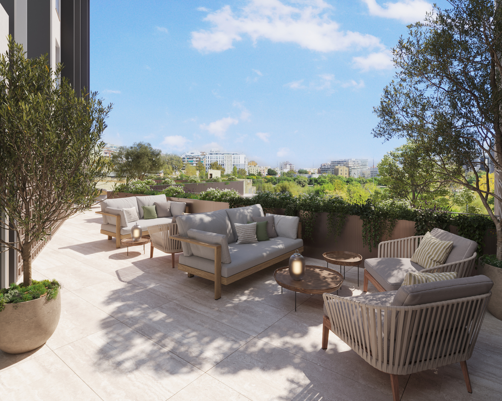 Private terrace with a round dining table, a lounge sofa, olive trees and wooden slat screens, framing the Torre Glòries and the city skyline.